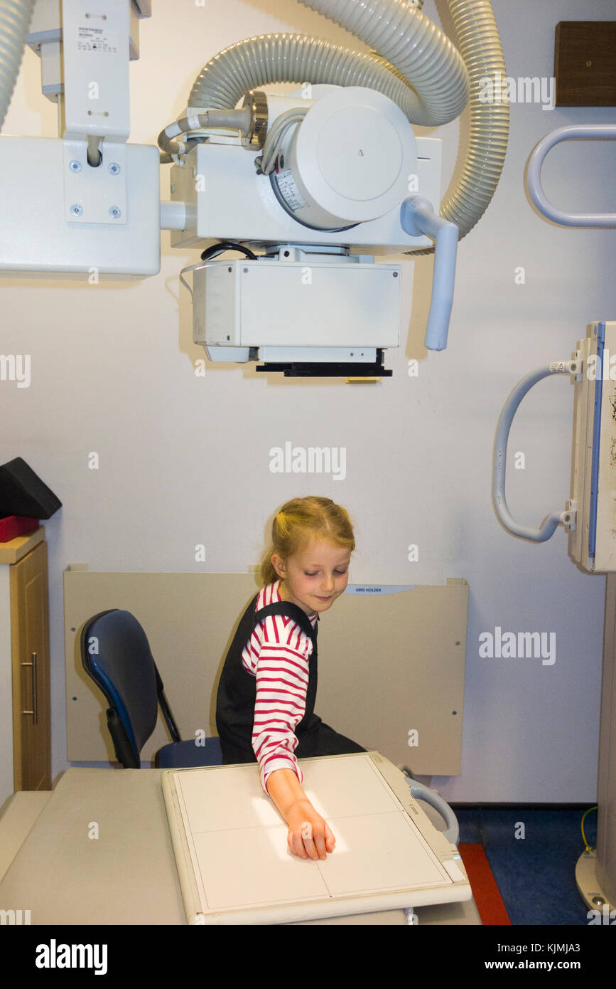 Child age 7 years / kid / girl / having an x ray of her arm for a suspected fracture to the wrist at an NHS non emergency walk in medical centre. (92) Stock Photo