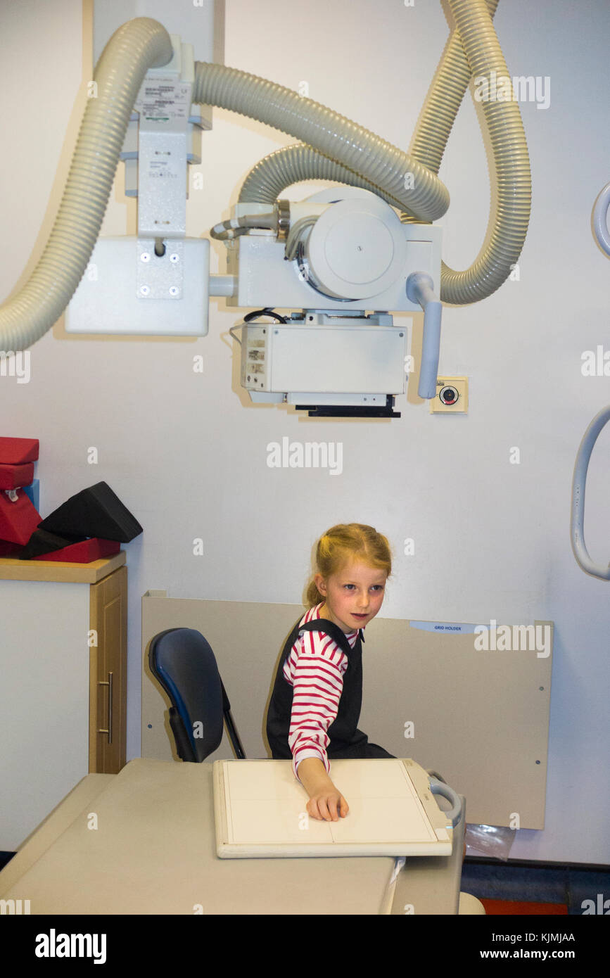 Child age 7 years / kid / girl / having an x ray of her arm for a suspected fracture to the wrist at an NHS non emergency walk in medical centre. (92) Stock Photo