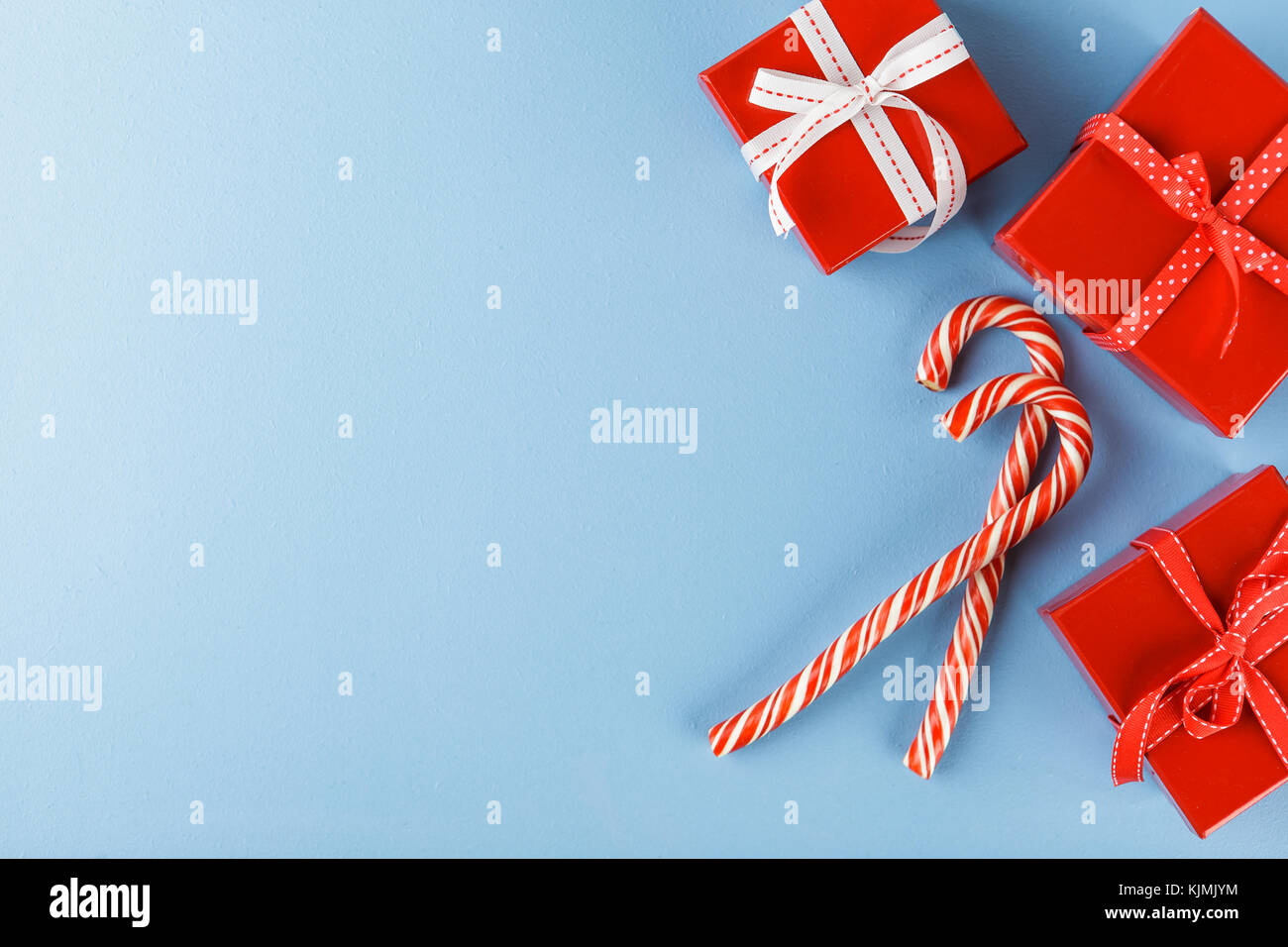 Christmas red gift boxes and Candy canes onblue background. Top view ...