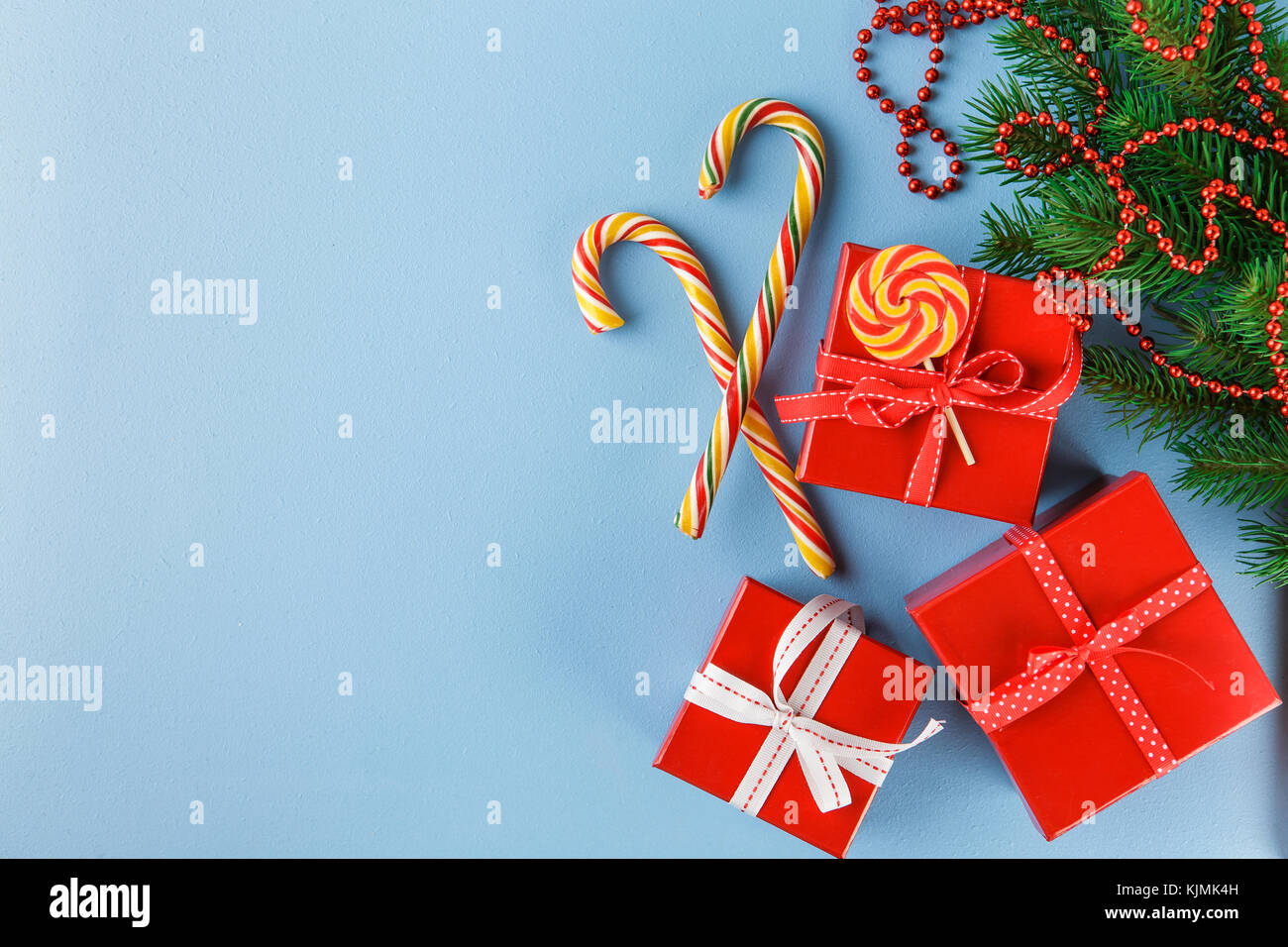 Christmas gift boxes, decorations, candy canes and fir tree branch on ...