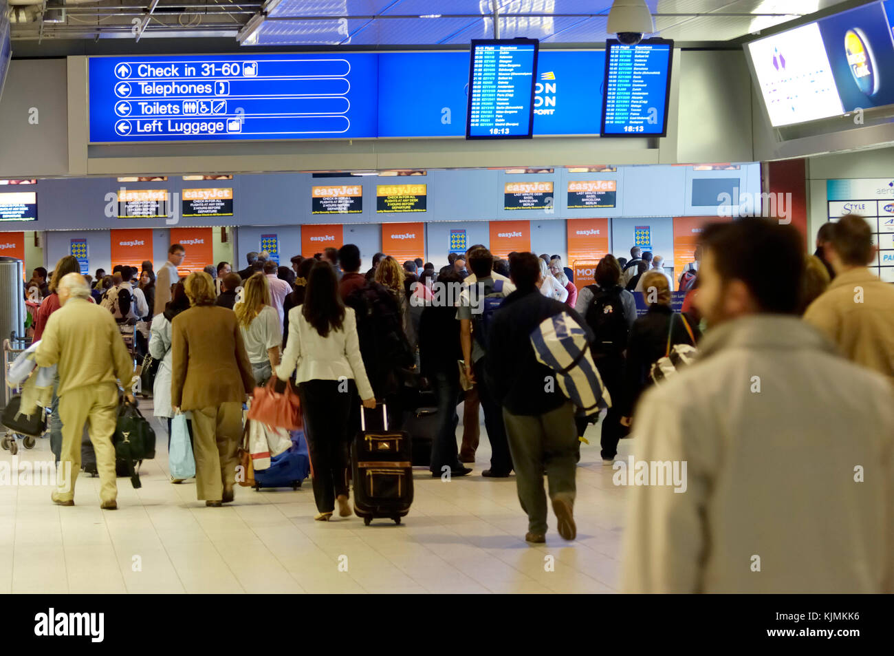 busy easyJet check-in with business-women, men and leisure passengers in a crowded queue Stock Photo