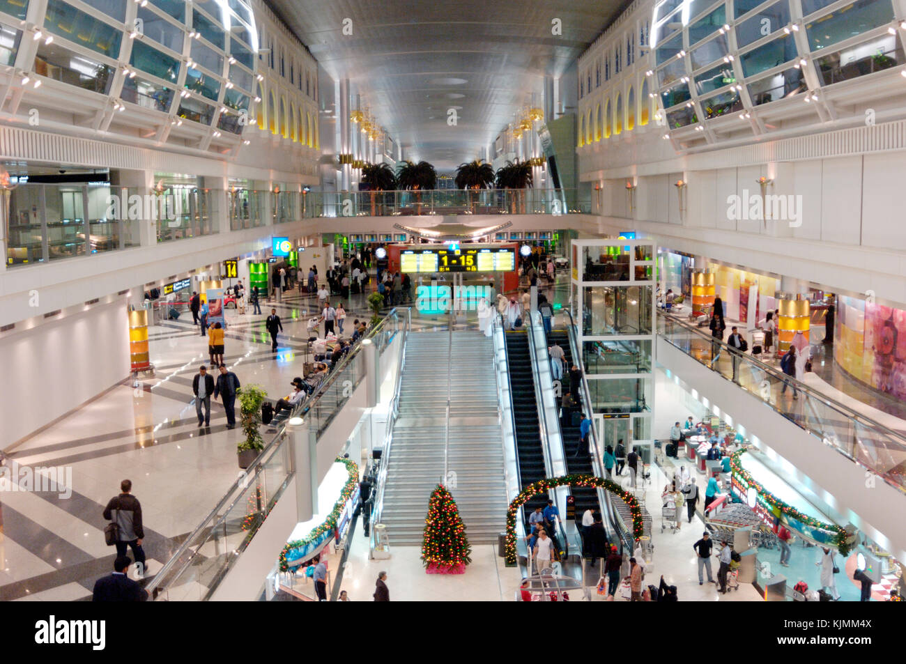 The Sheikh Rashid passenger terminal at Dubai International airport. Elevated view, passengers using travelators and smooth escalators between floors. Stock Photo