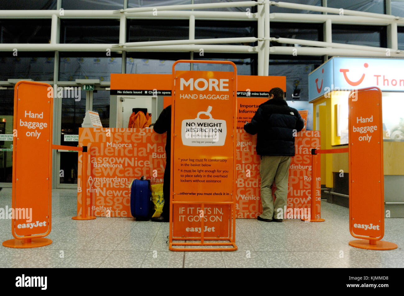 man at easyJet carry-on baggage only check-in desks Stock Photo