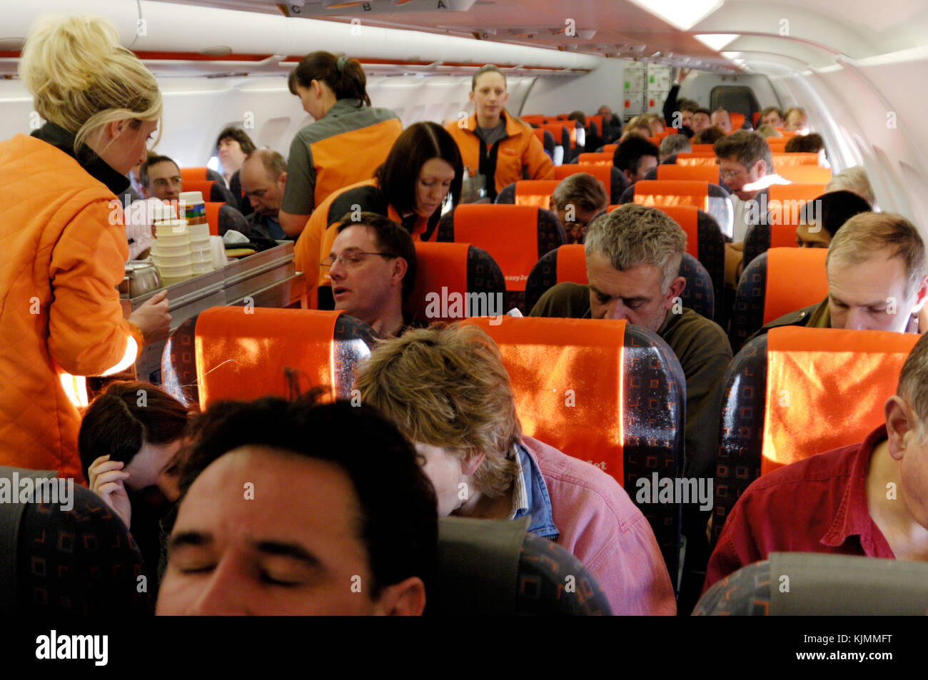 stewardesses and passengers in the economy-class cabin BRS-GVA Stock Photo