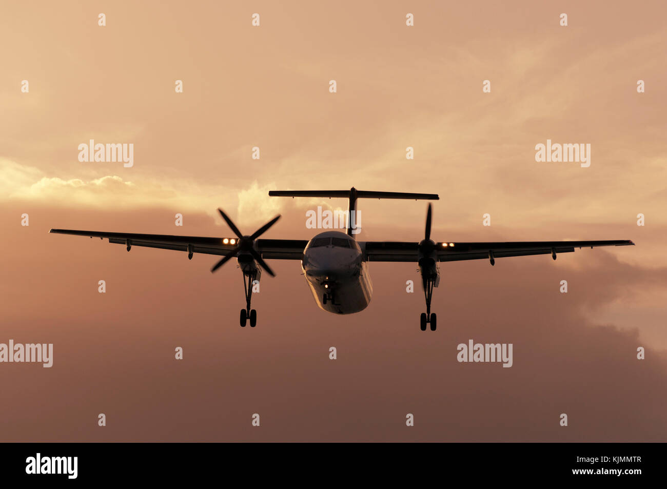 A Bombardier DHC-8 Dash 8 turboprop aircraft in the air. Stock Photo