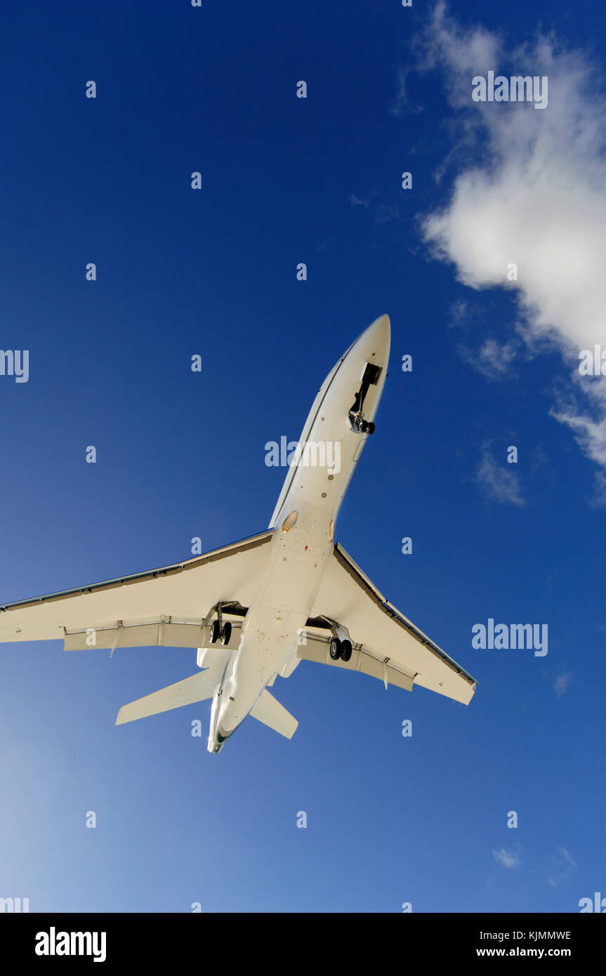 Very low on final-approach to landing with cumulus clouds behind Stock Photo