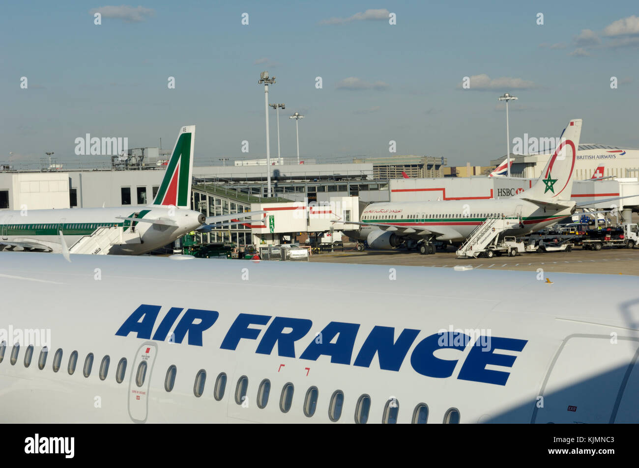 an Air France Airbus A319 with an Alitalia A321-100 and Royal Air Maroc Boeing 737-800 parked behind at Terminal2 Heathrow Stock Photo