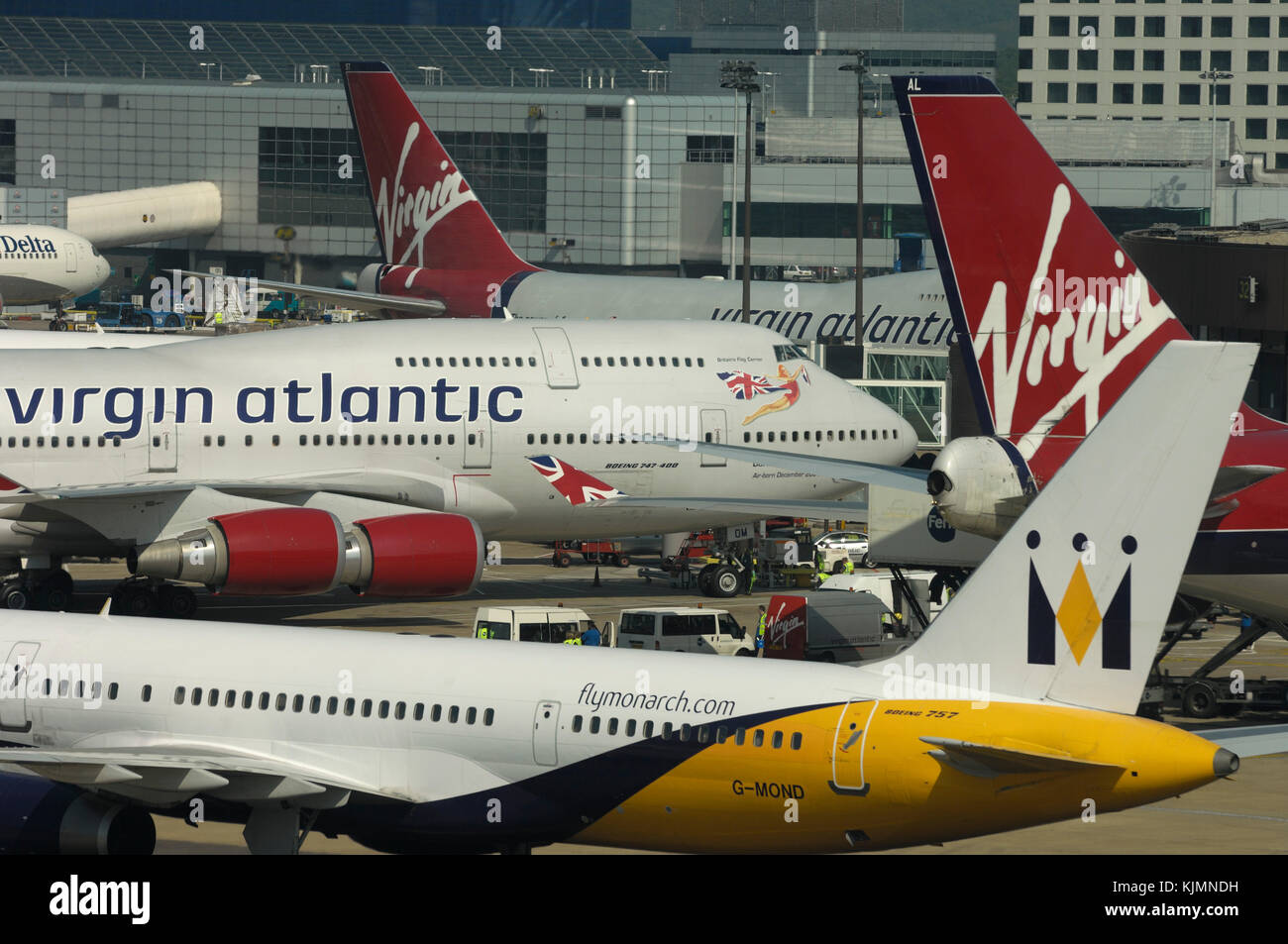 a Monarch Boeing 757-200, three Virgin Atlantic 747-400s parked at the terminal behind Stock Photo
