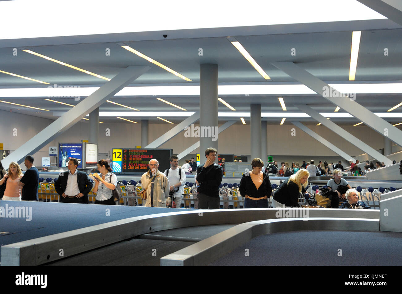 passengers waiting at the baggage carousel in the terminal Stock Photo