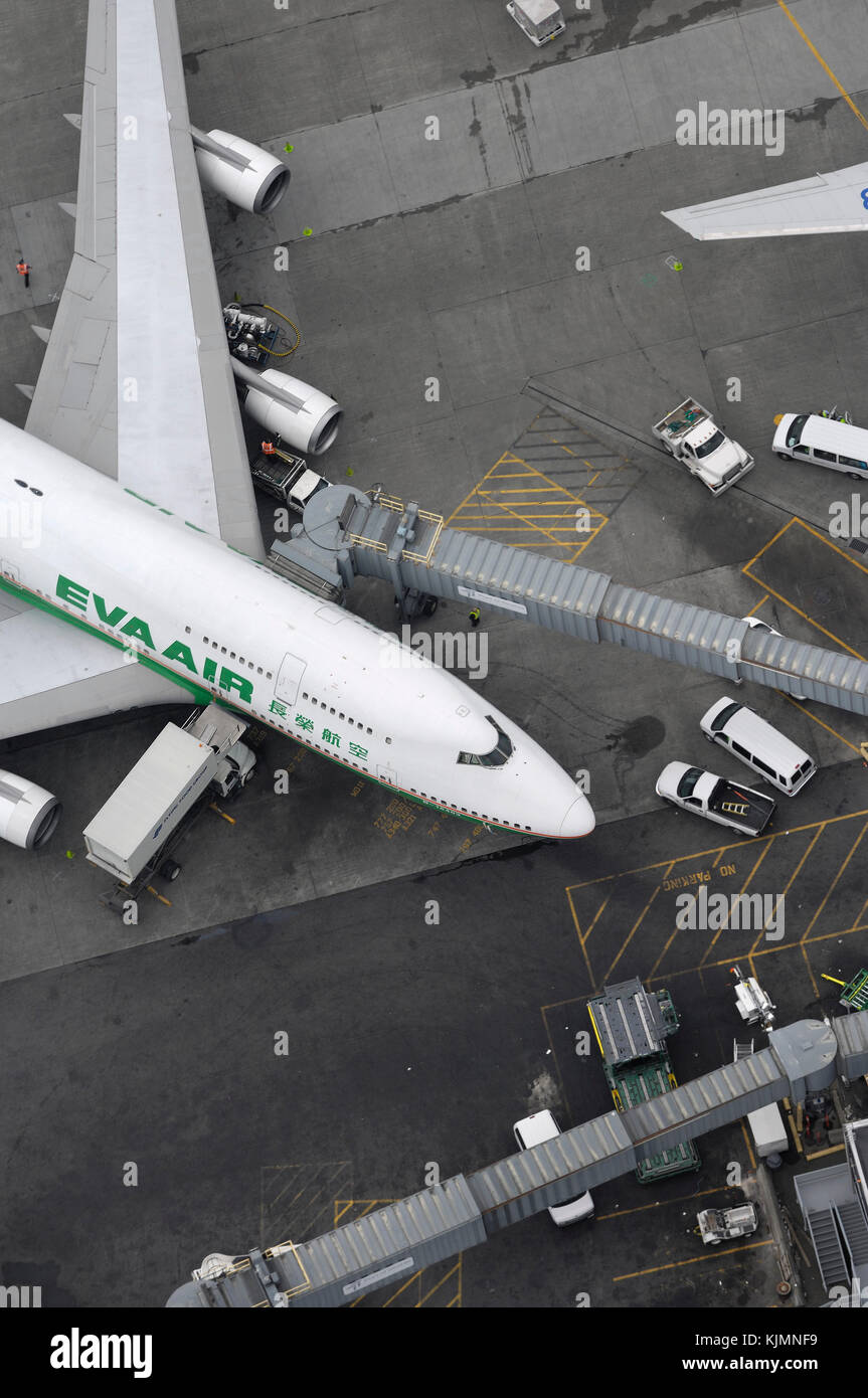 an EVA Air Boeing 747400 parked at the terminal with jetway extended