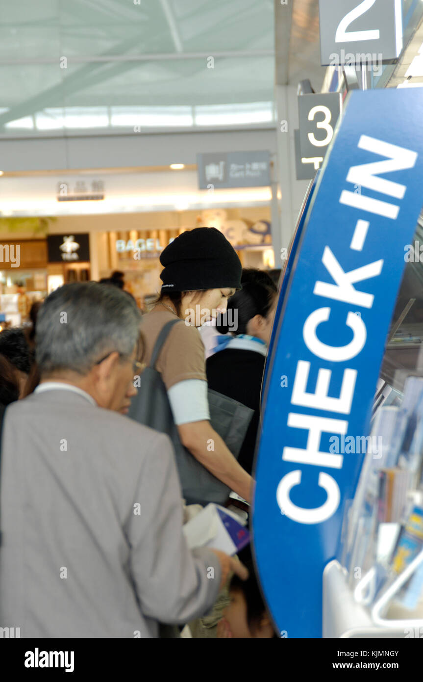passengers using e-ticket, e-check-in machines in main airport terminal building Stock Photo
