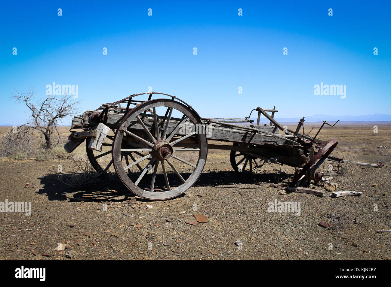 Old broken wagon in the desert Stock Photo