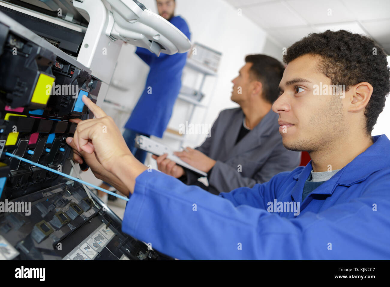 apprentice is learning to fix a printer Stock Photo Alamy