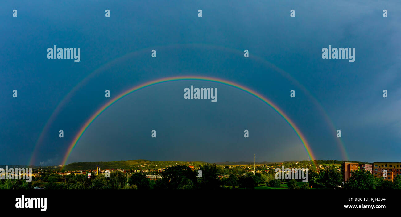 Rainbow in the city after rain Stock Photo - Alamy