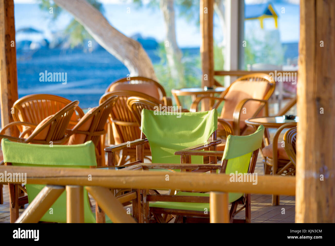 Tables and chairs in a street restaurant in Kamari on Santorini Stock Photo