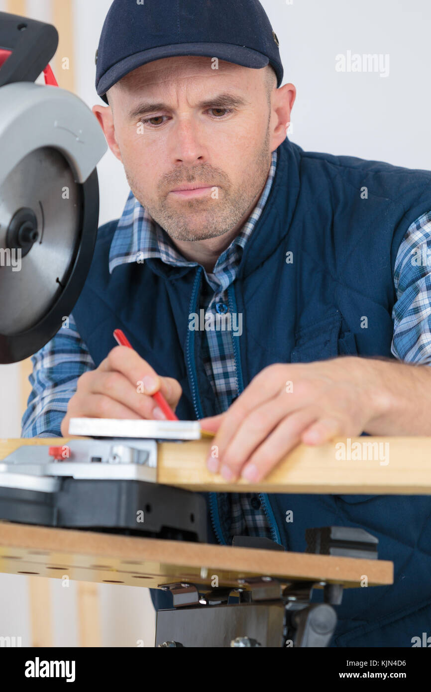 man measuring wooden planks with tape and pencil Stock Photo Alamy