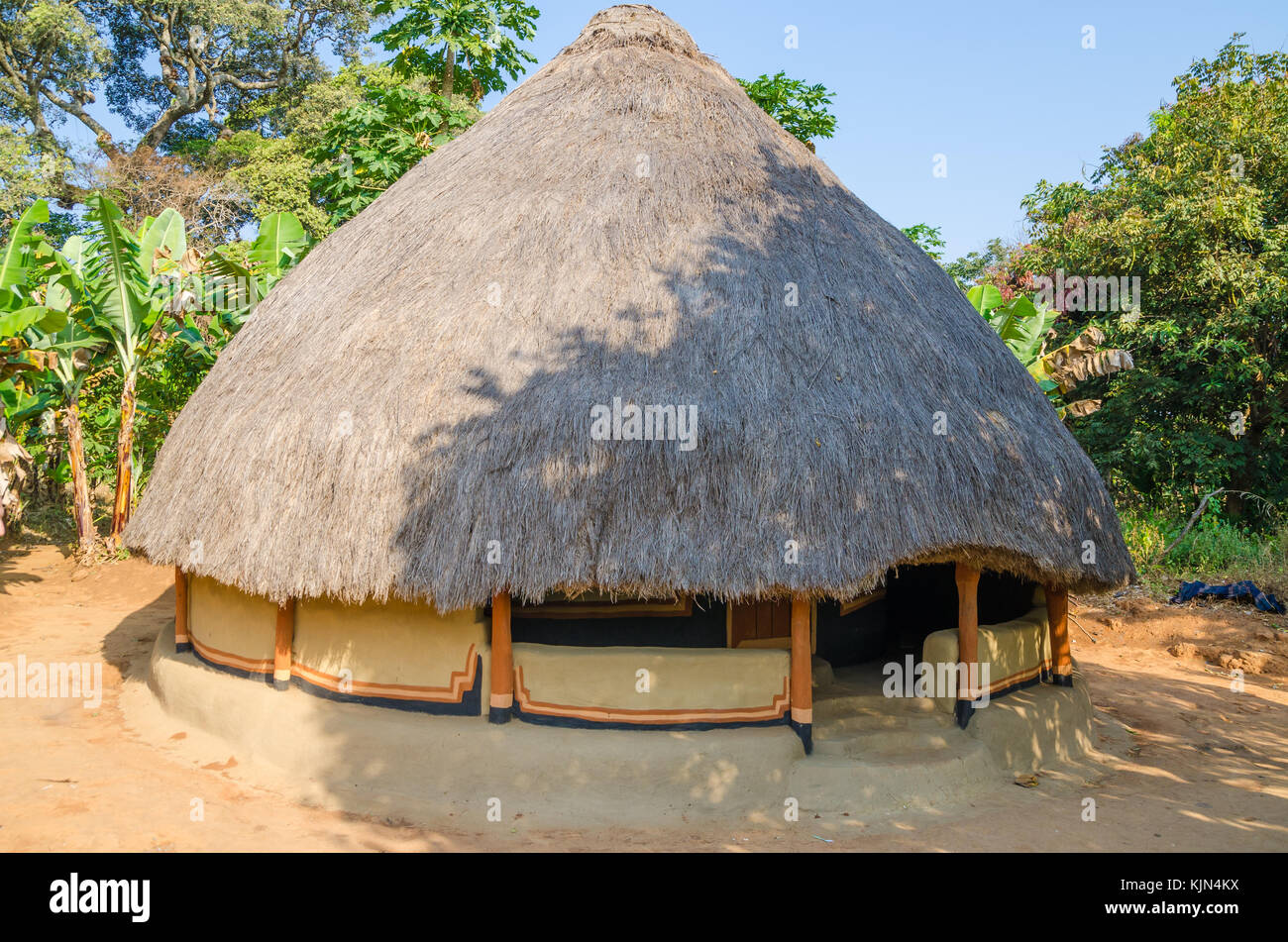 Beautiful and colorful traditional thatched round mud and clay hut in rural village of Guinea Bissau, West Africa Stock Photo