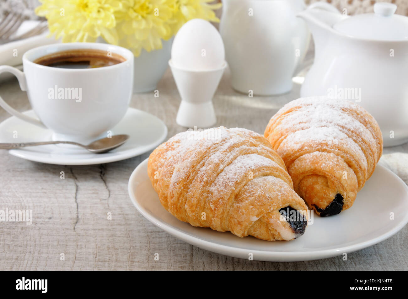 Croissants with chocolate filling cup and fresh morning coffee. Foreground close-up Stock Photo