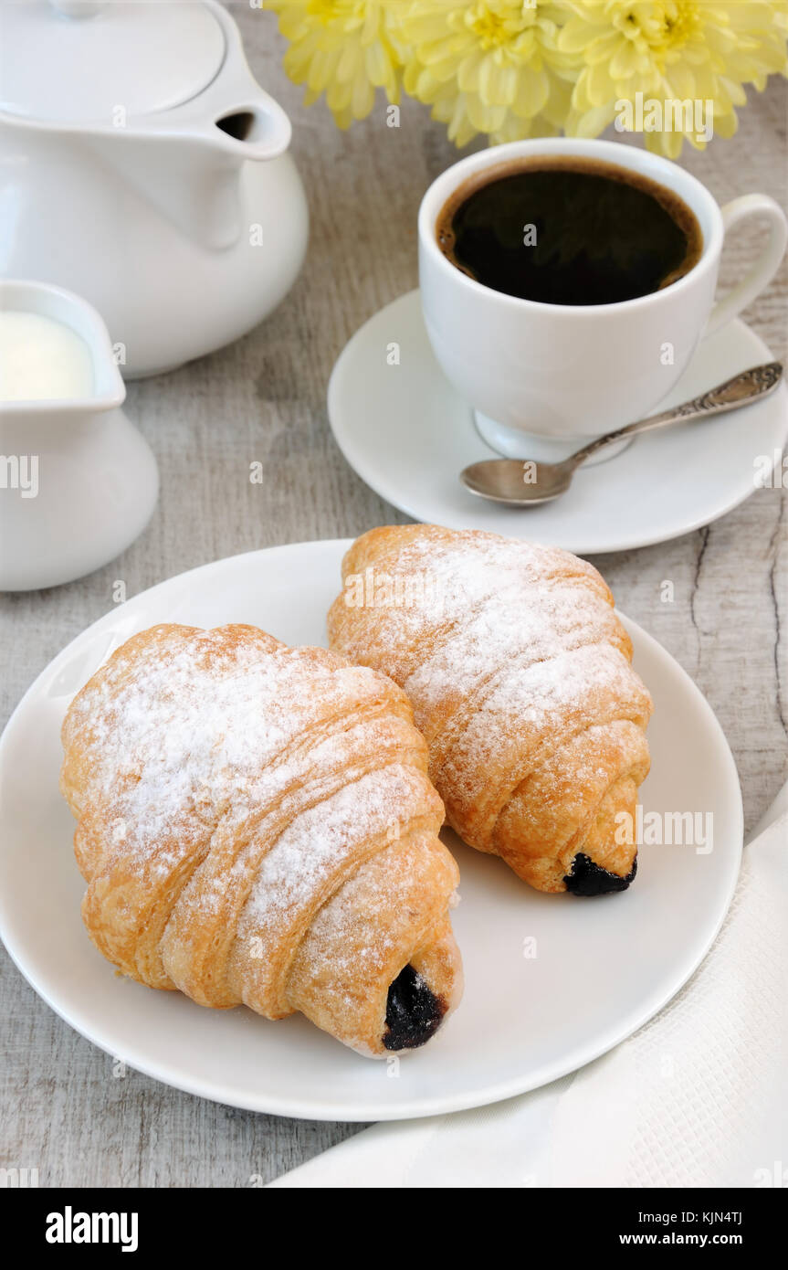 Croissants with chocolate filling cup and fresh morning coffee. Stock Photo