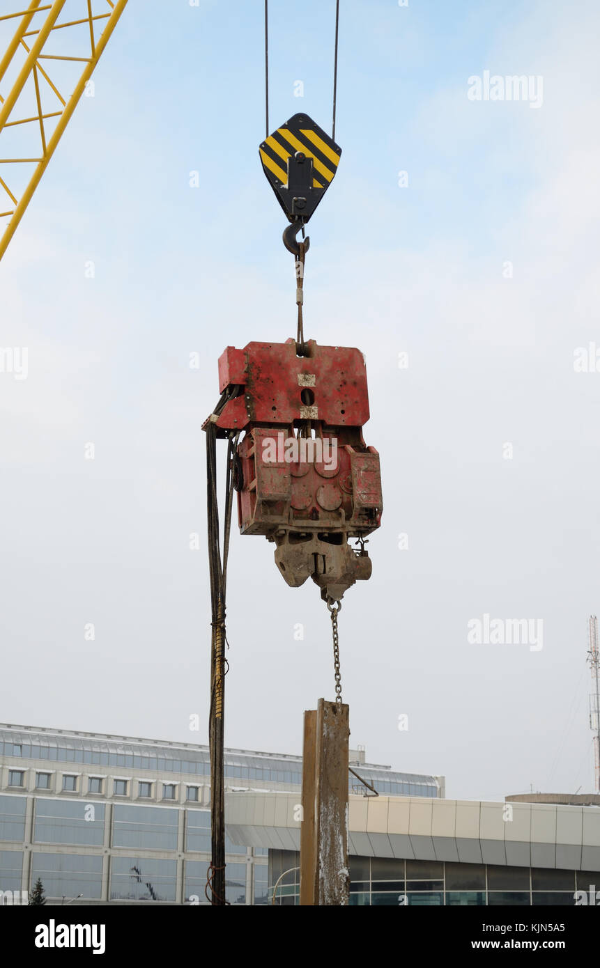 At the construction site with a crane lift various loads. Stock Photo