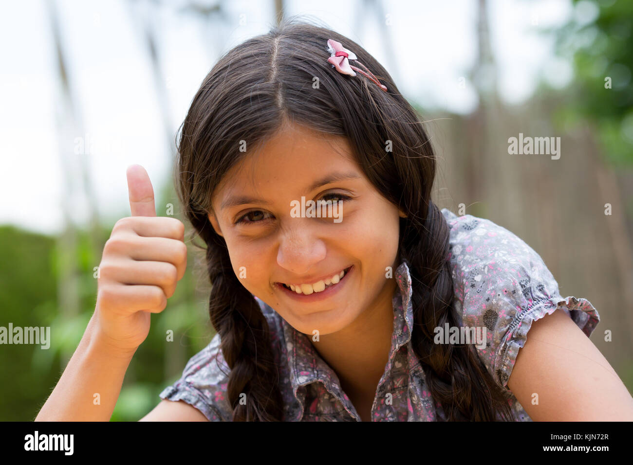 Girl with thumbs up - shot outdoor Stock Photo - Alamy