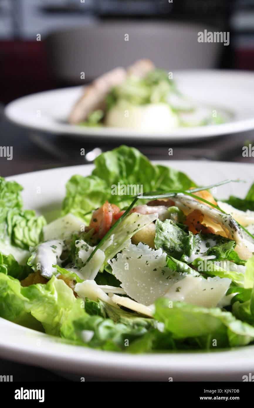 close up of caesar salad bowl in restaurant Stock Photo Alamy