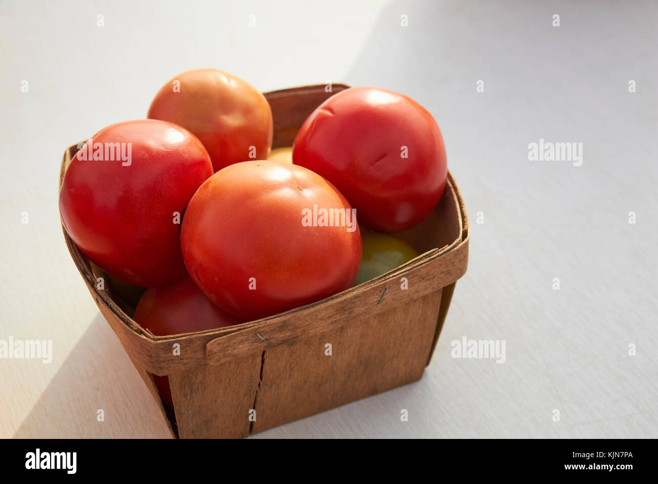 a quart basket of tomatoes at a Lancaster County Pennsylvania farmer's market Stock Photo