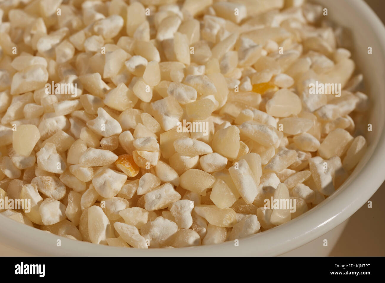 A bowl of dried white hominy, corn, called  maiz trillado or Morocho Partido in Spanish Stock Photo