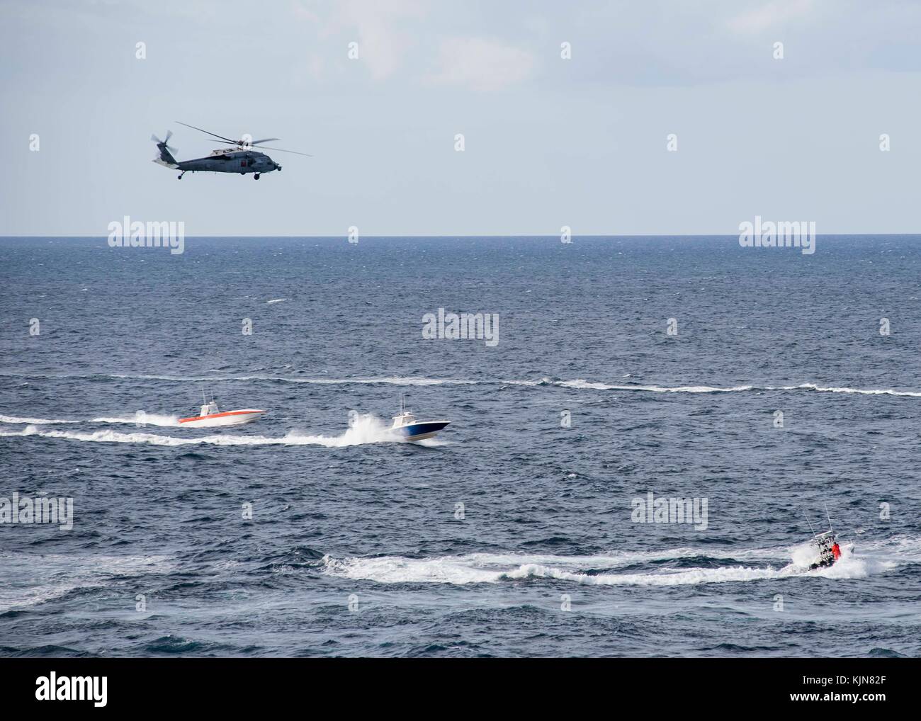 MH-60S Sea Hawk deters a fast attack craft during a fast inshore attack craft encounter during Stock Photo