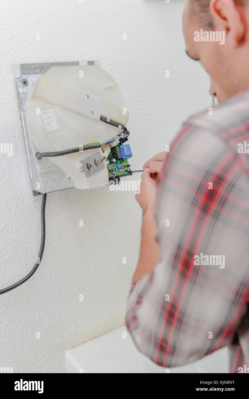 Trying to fix a hand dryer Stock Photo Alamy