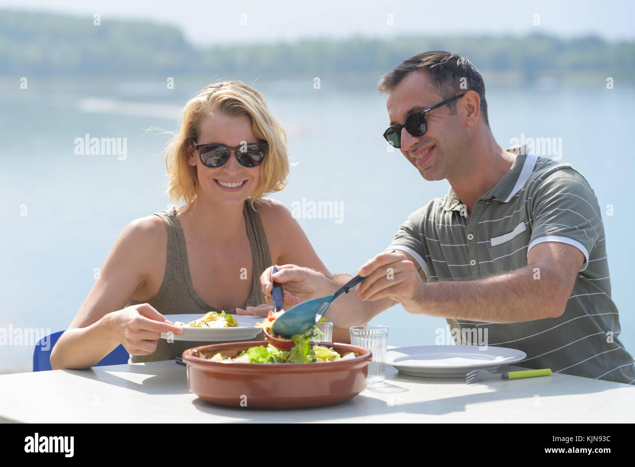 happy couple eating salad for dinner at cafe terrace Stock Photo Alamy