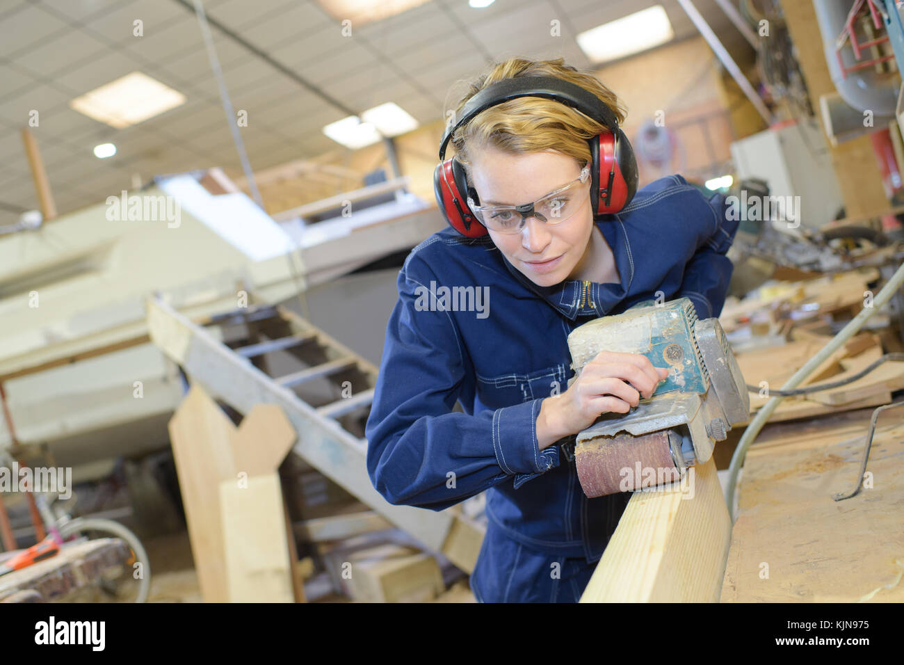 female apprentice using plane Stock Photo - Alamy