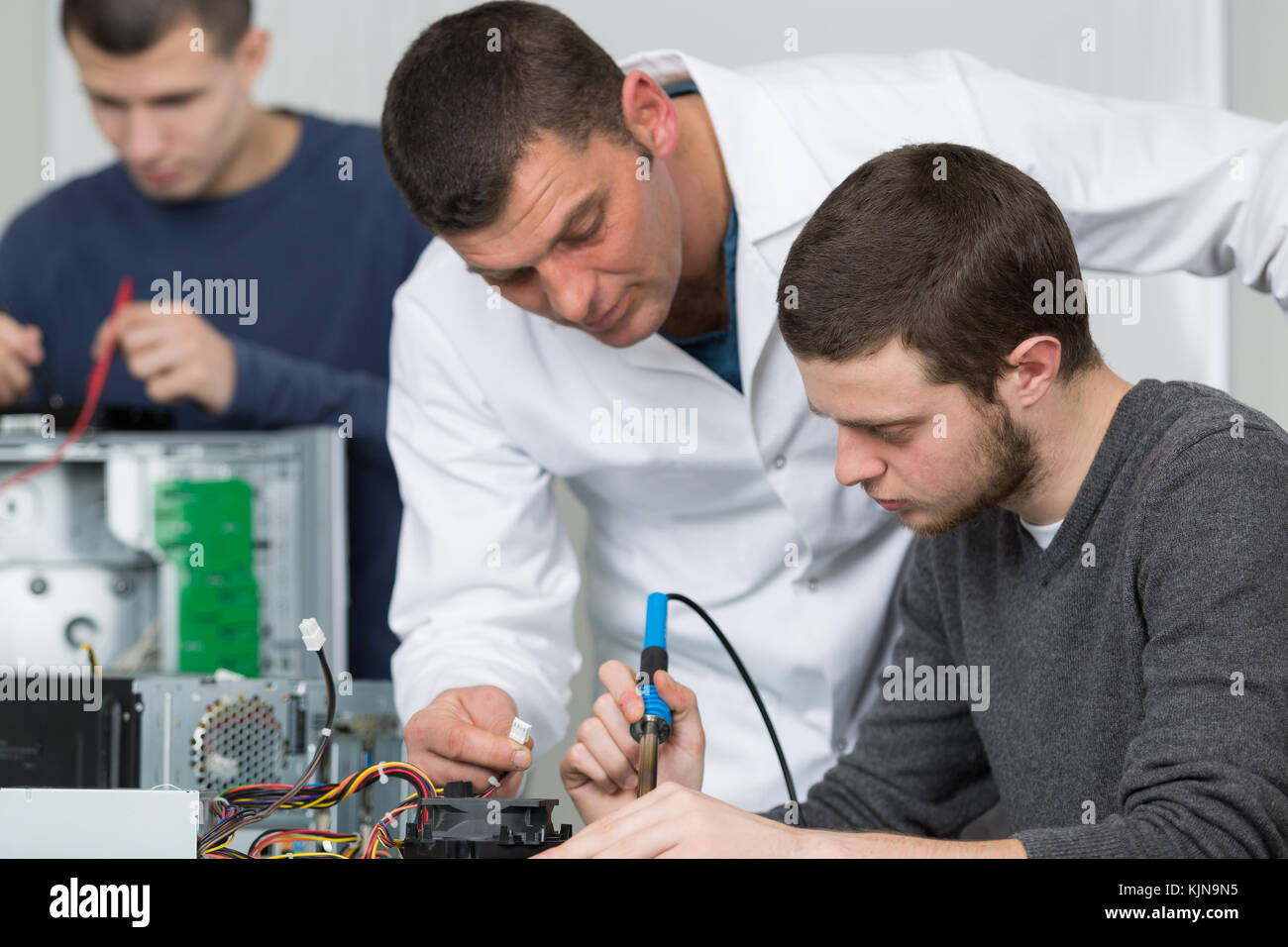 electronic assembler using a soldering iron Stock Photo Alamy
