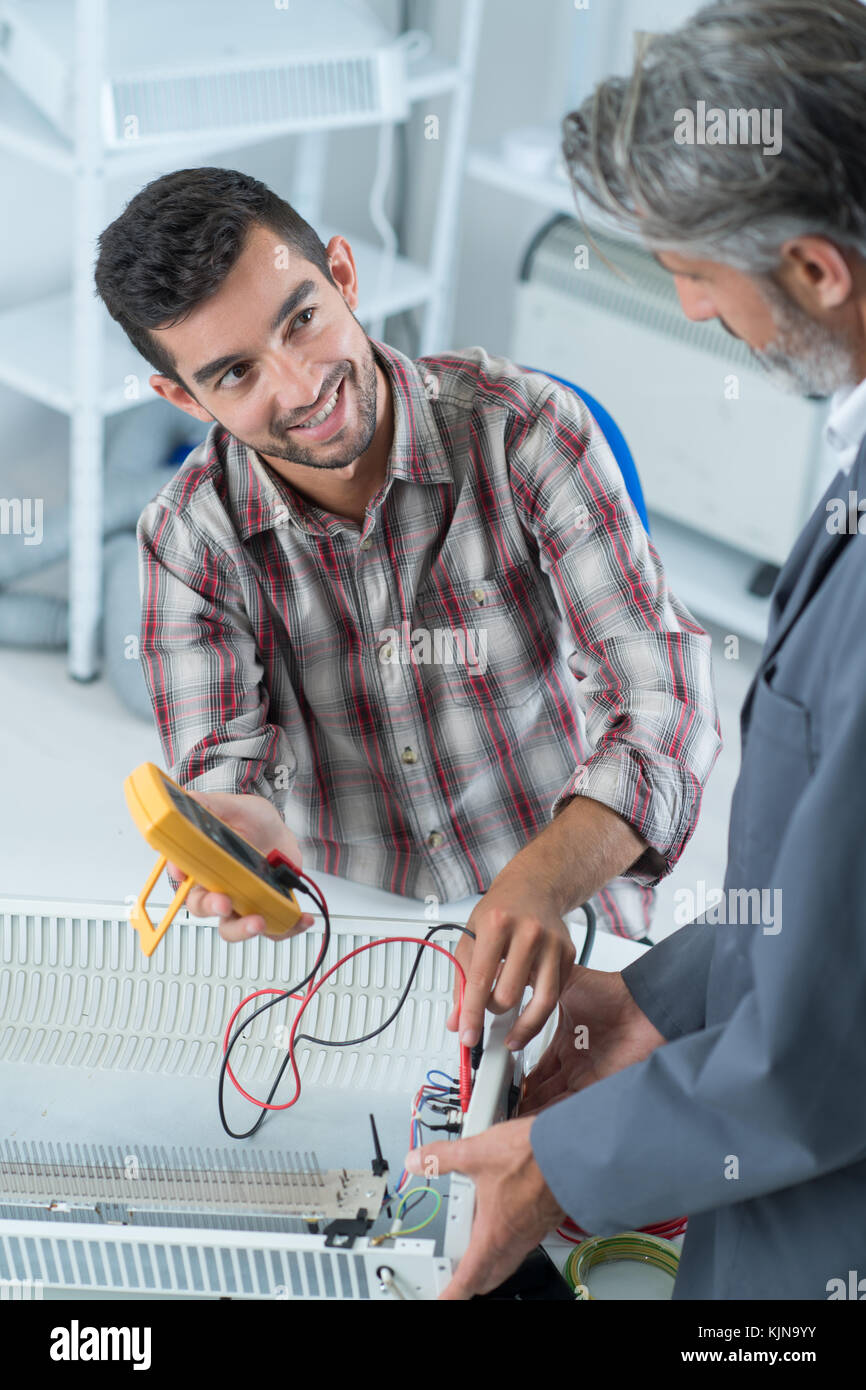 happy apprentice helped by teacher Stock Photo - Alamy