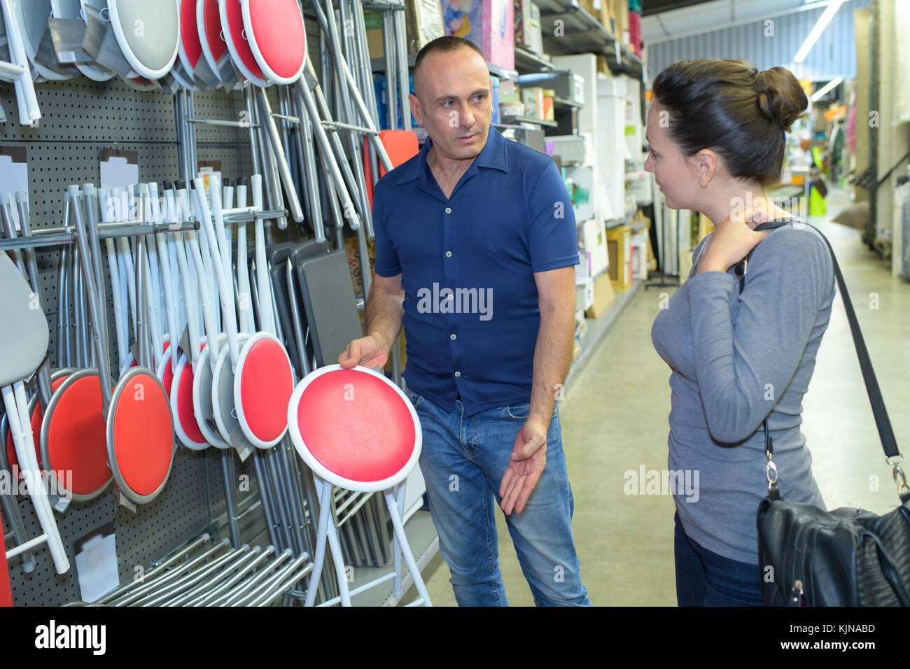 couple choosing chairs at hardware store Stock Photo