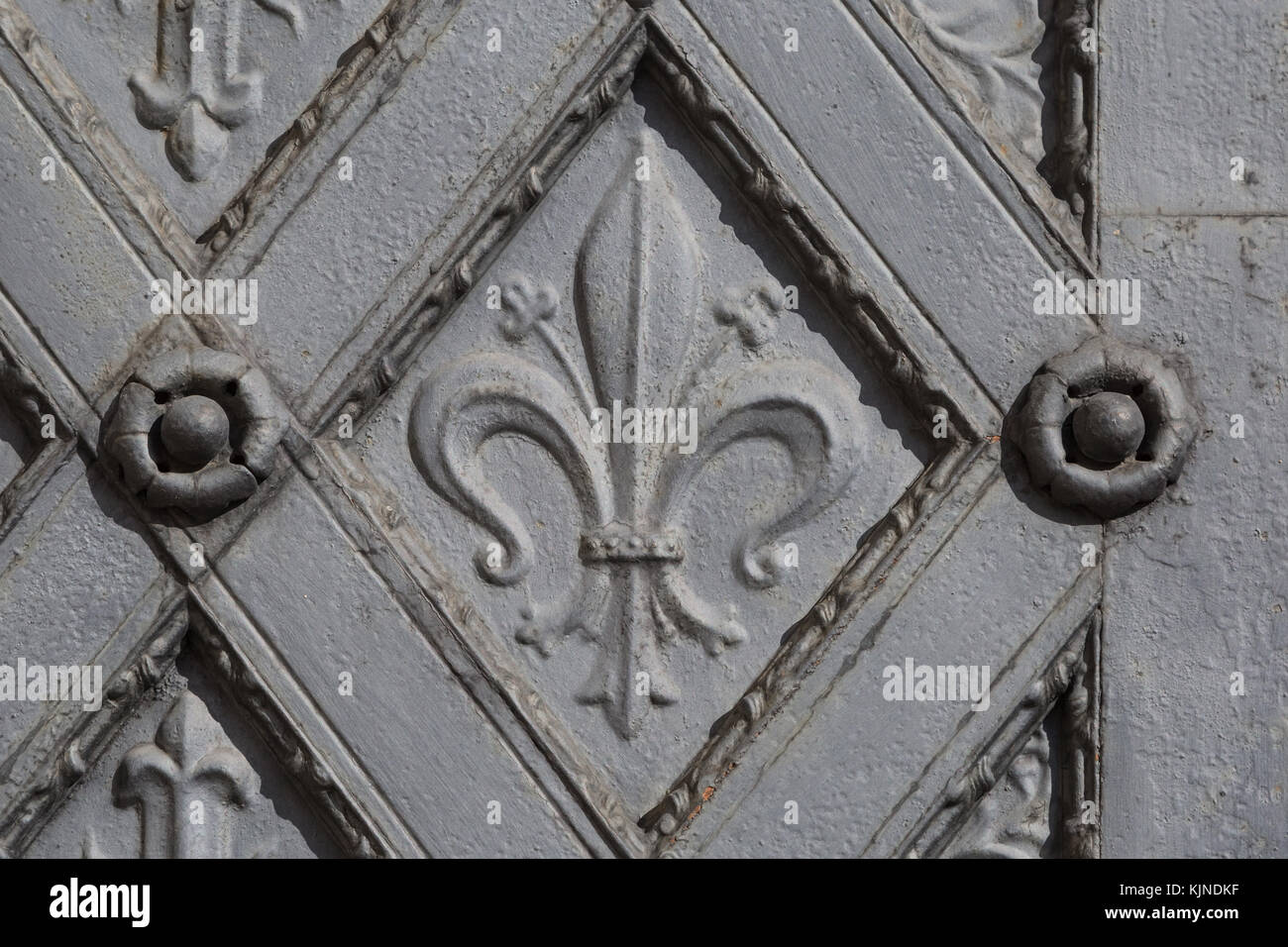 Ornament in the shape of fleur de lis and cross on a metal door in monastery Klosterneuburg, Austria Stock Photo