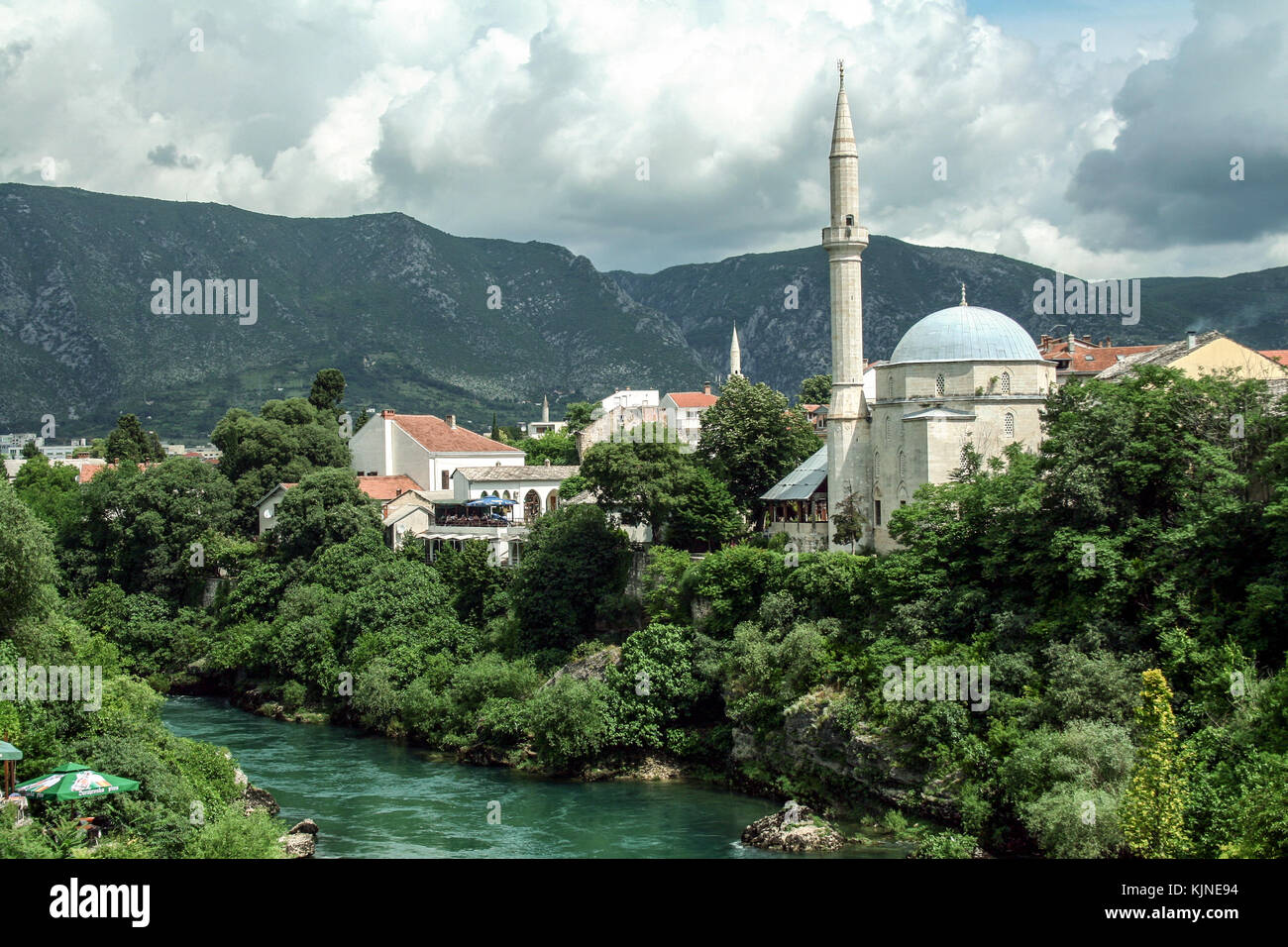 Karadjozbegova mosque seen from its opposite bank of the river Neretva in Mostar, Bosnia and Herzegovina. It is one of the landmarks of the city.  Pic Stock Photo