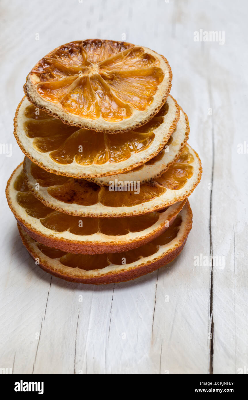 Dried oranges on white wood. Stock Photo