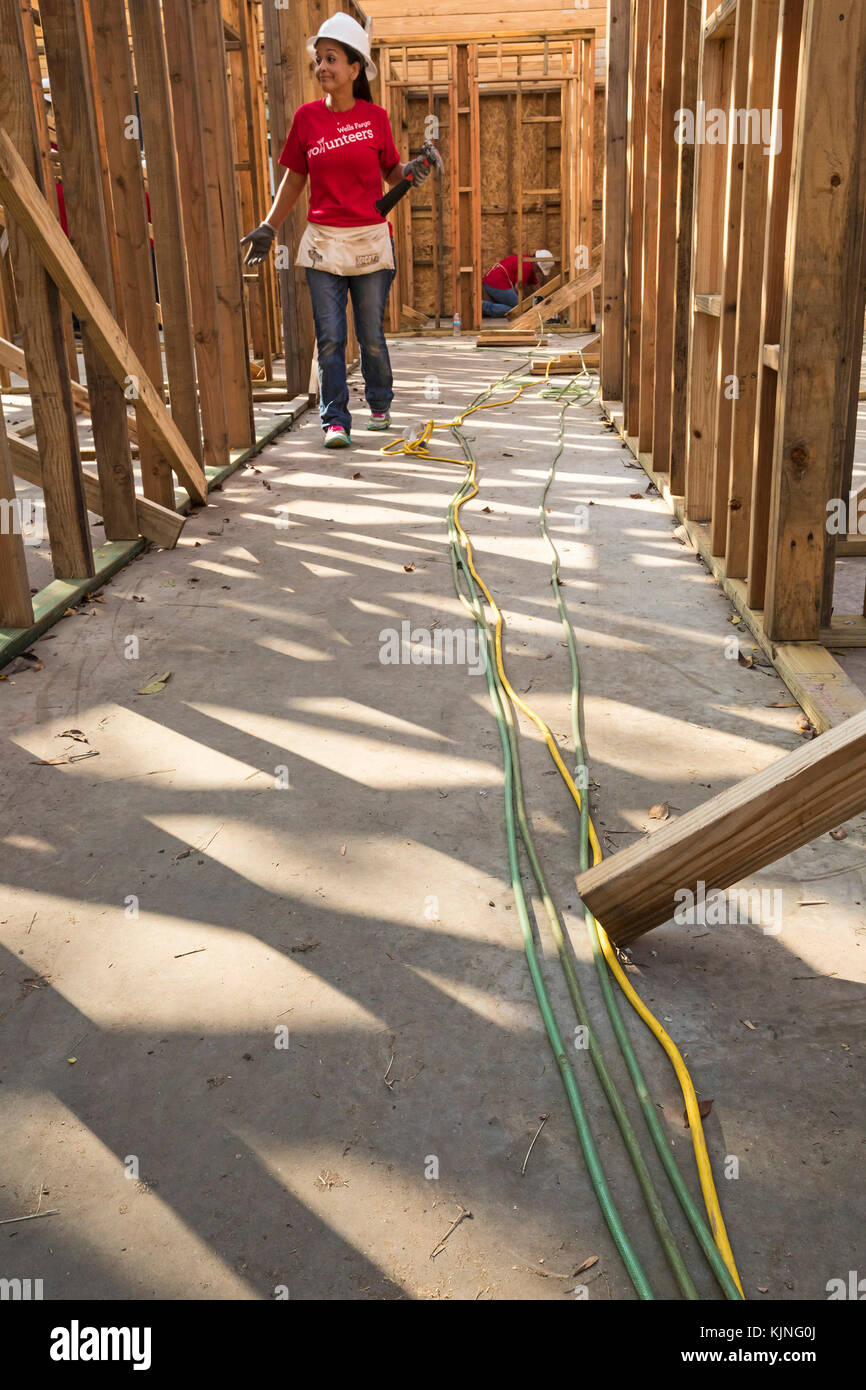 Houston, Texas - Volunteers from Wells Fargo Bank help build a Habitat for Humanity house for a low-income family. The need for affordable housing in  Stock Photo