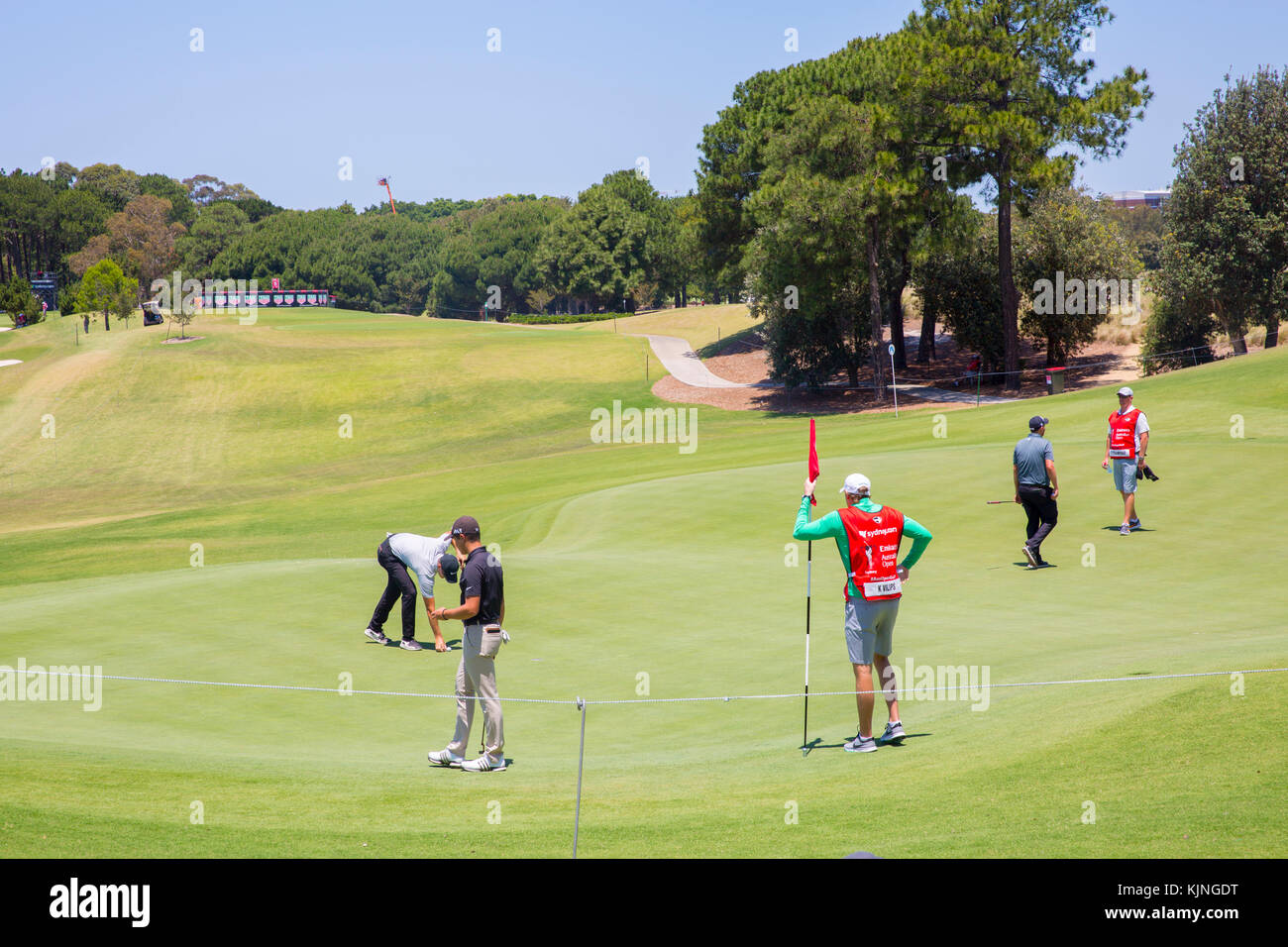 Professional golfers putting on the green at the Emirates Australian