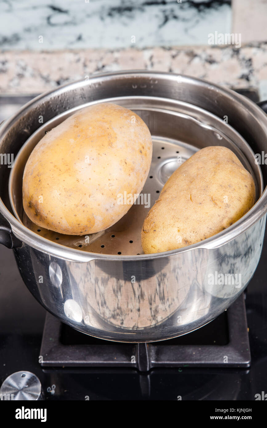 Whole potatoes steam boiled in a pressure cooker Stock Photo Alamy