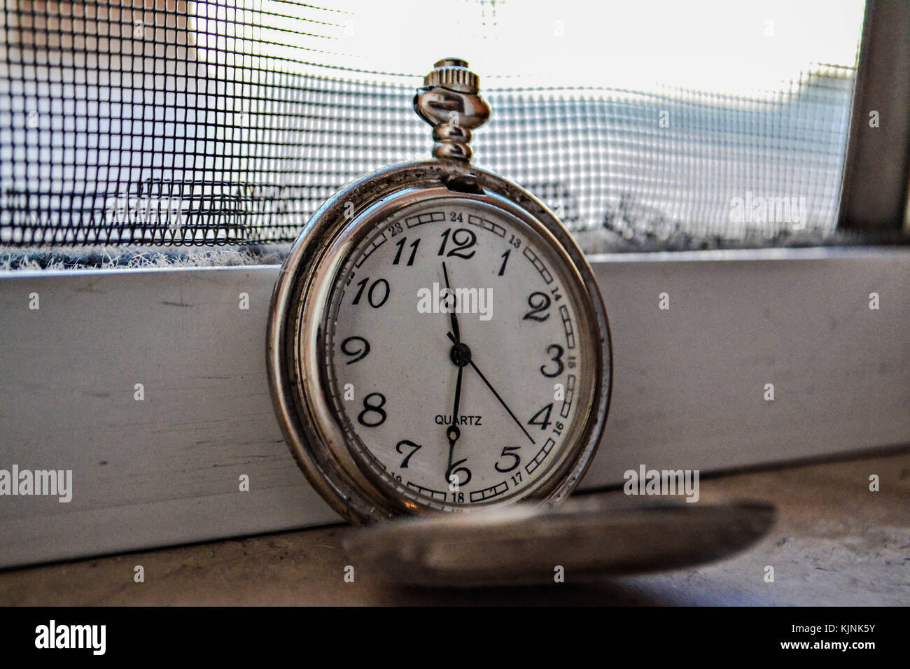 Time for Waiting with Vintage Pocket Watch by the window,Image for Deadline Time Concept Stock Photo