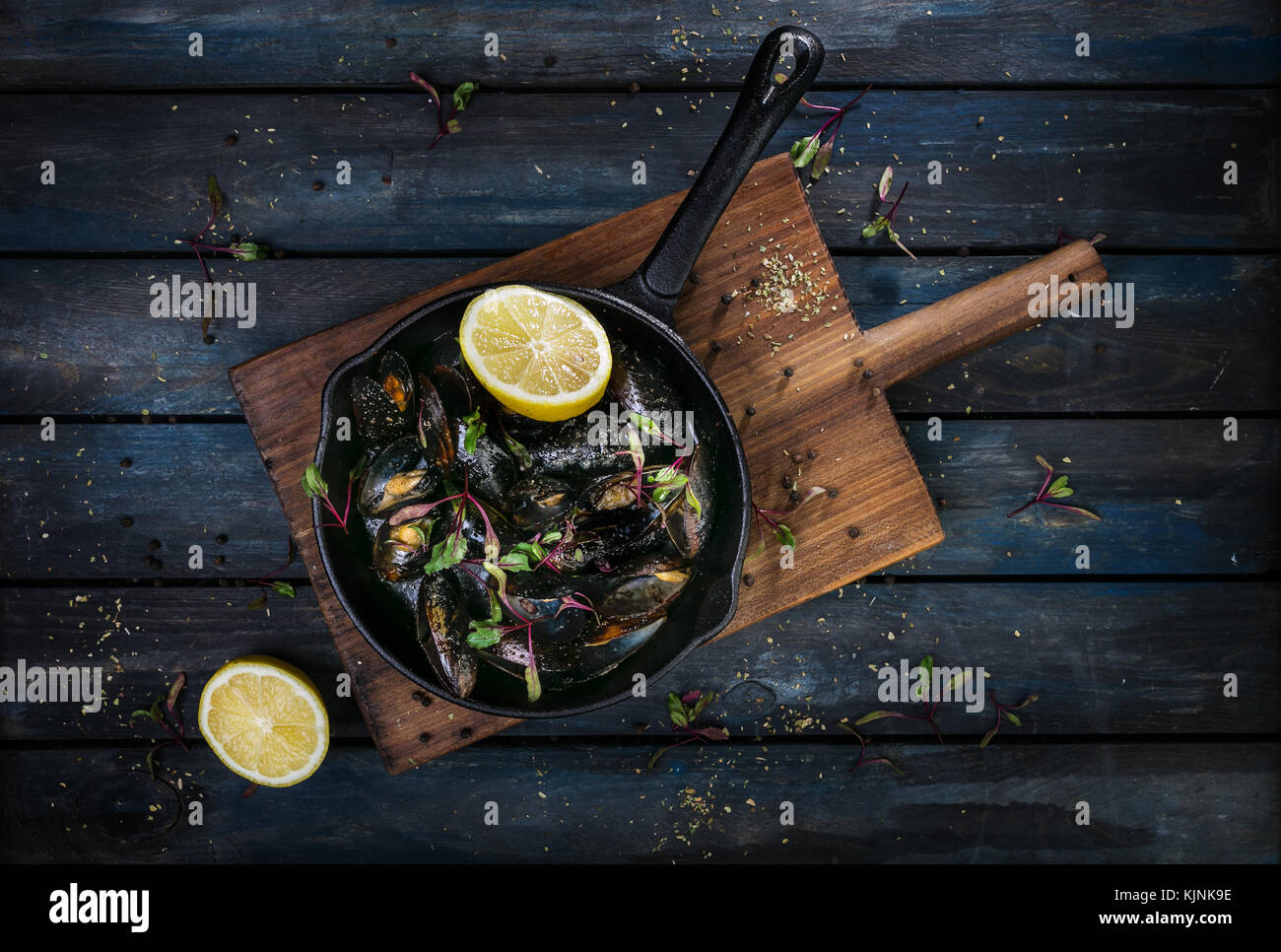 Delicious mussels. Serving on a hot frying pan with herbs spices and