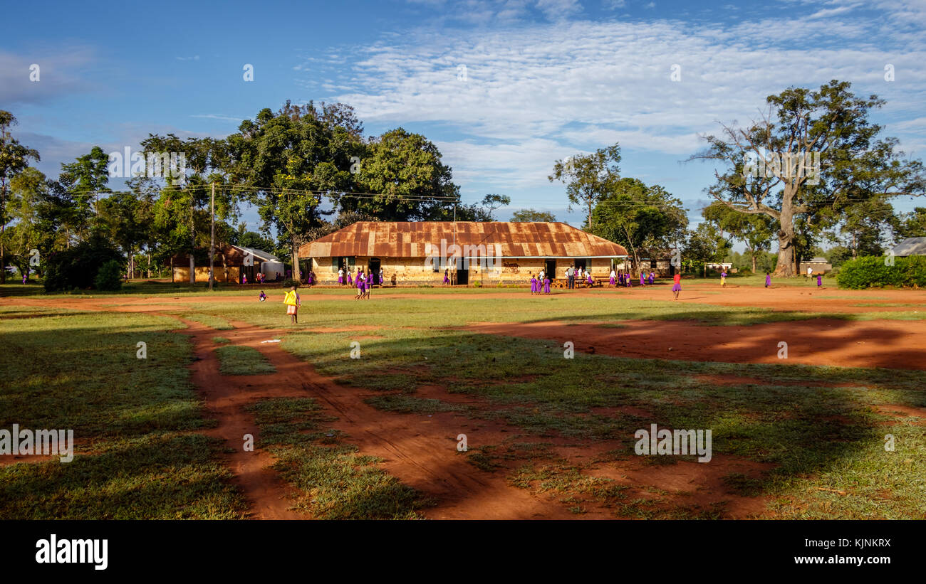 KOLONYI, UGANDA – NOVEMBER 09, 2017: Many students with purple uniform waiting to enter the primary school in Kolonyi near Mbale in Uganda on a beauti Stock Photo