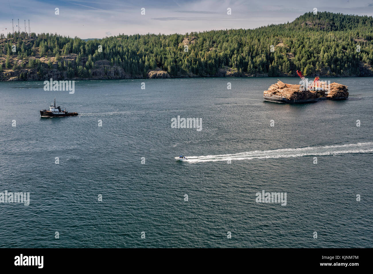 Tugboat towing ITB Beaufort Sea, barge loaded with timber, Seymour Narrows at Discovery Passage, Vancouver Island in dist, British Columbia, Canada Stock Photo