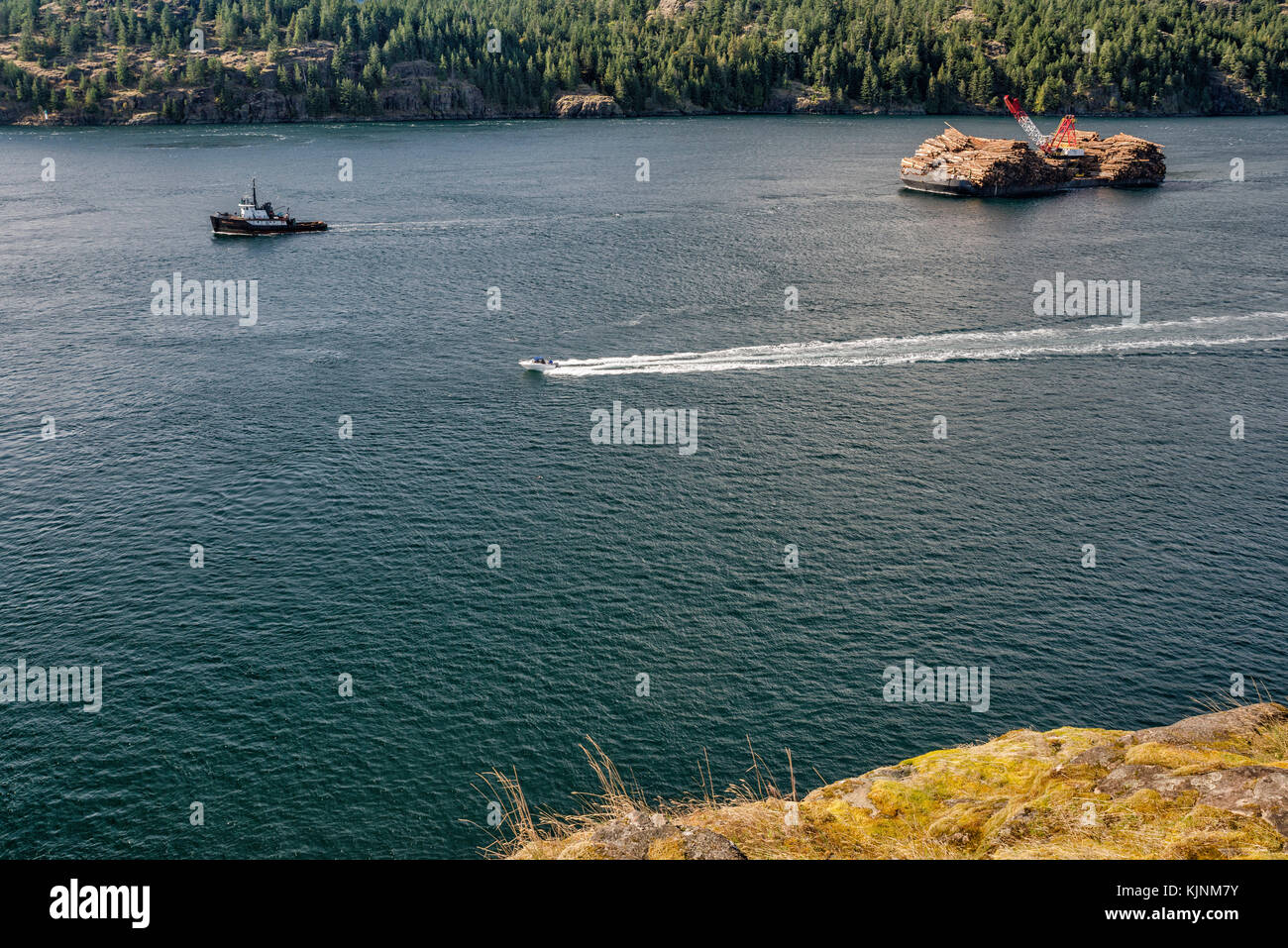 Tugboat towing ITB Beaufort Sea, barge loaded with timber, Seymour Narrows at Discovery Passage, Vancouver Island in dist, British Columbia, Canada Stock Photo