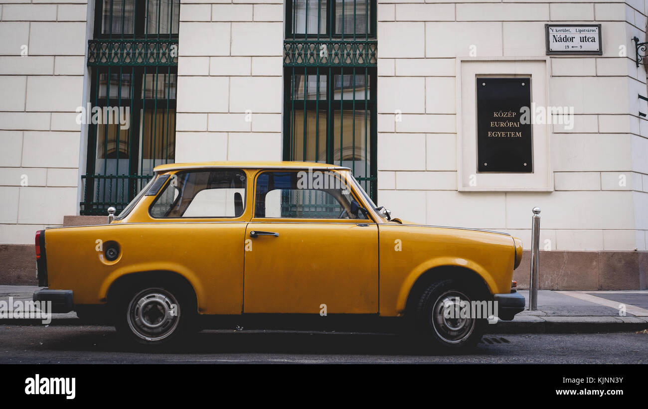Vintage yellow Trabant 1.1 parked in a street in Budapest (Hungary). June 2017. Landscape format. Stock Photo