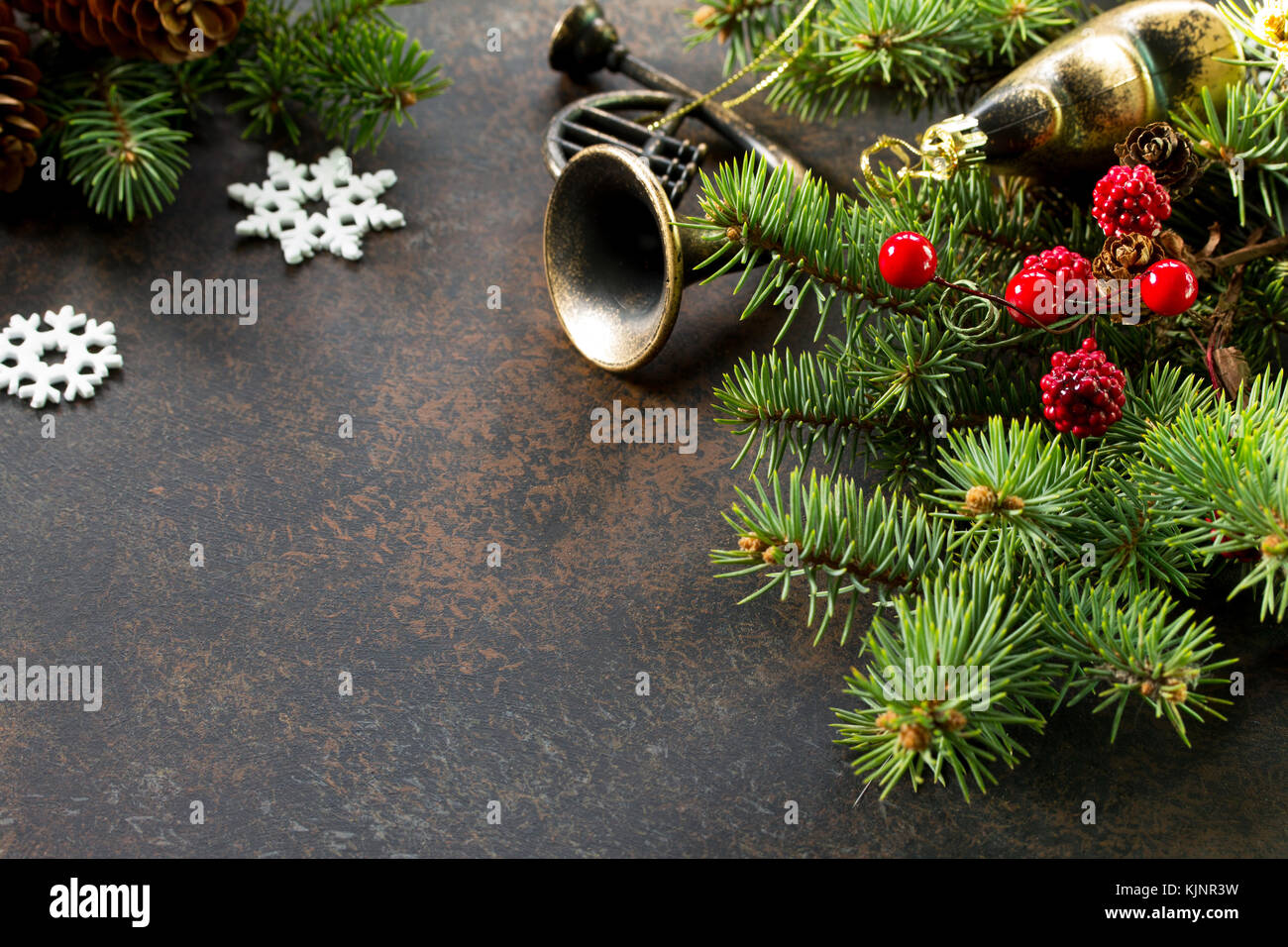 Christmas background frame or greeting xmas card. Christmas tree and decorative ornaments on a dark stone and slate background. Flat lay, top view wit Stock Photo