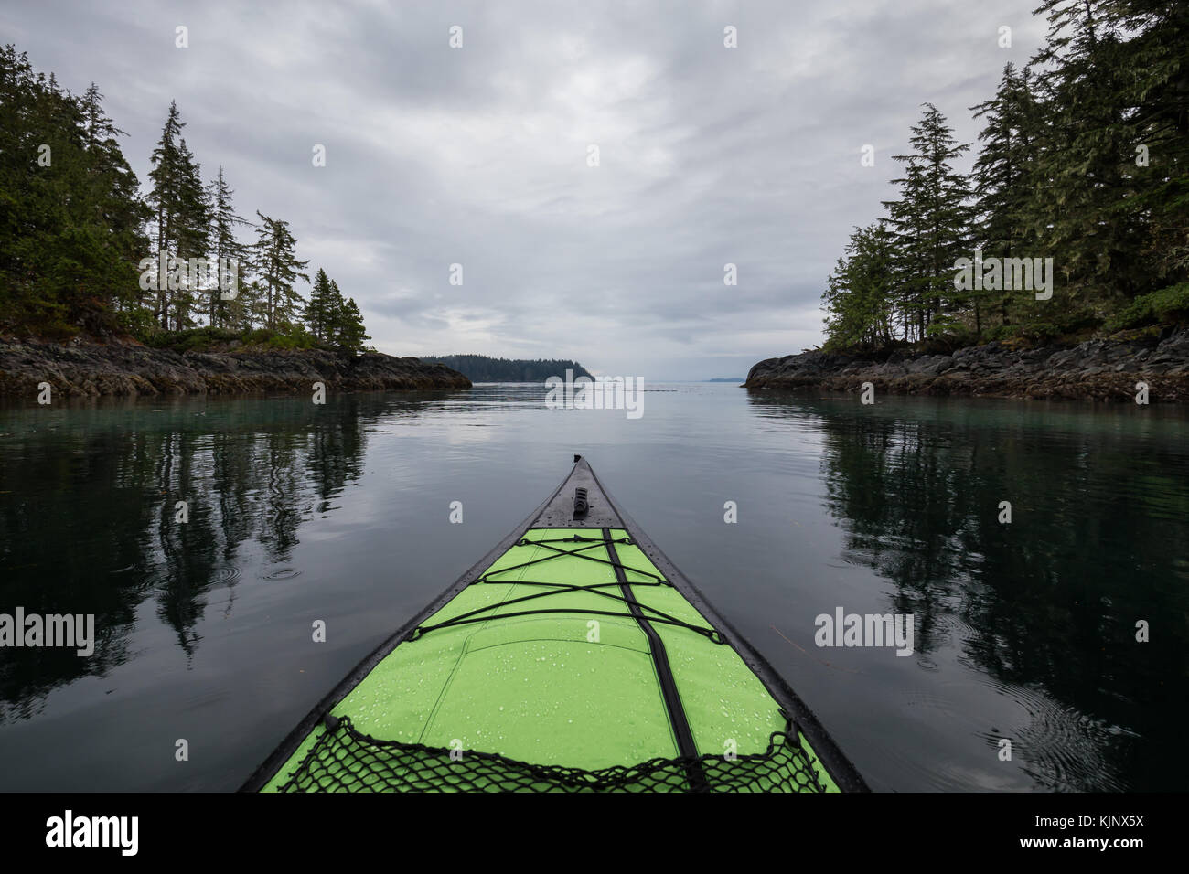 Kayaking on an inflatable kayak in the peaceful ocean by rocky islands