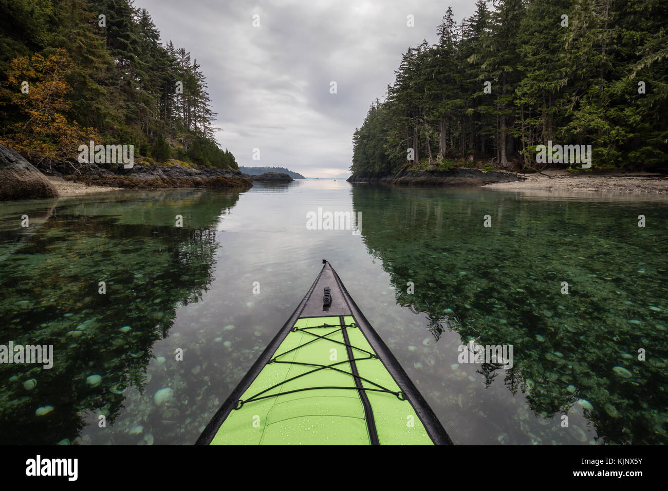 Kayaking on an inflatable kayak in the peaceful ocean by rocky islands